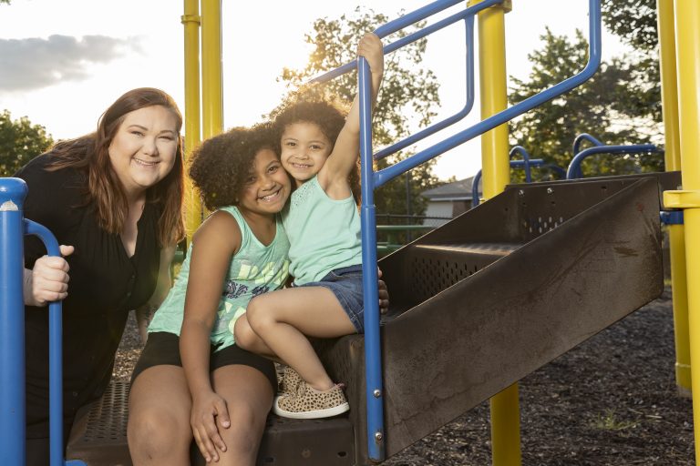 Hannah Milster and her daughters Nancy, 9, and Mia, 4, at the playground of Tara Apartments