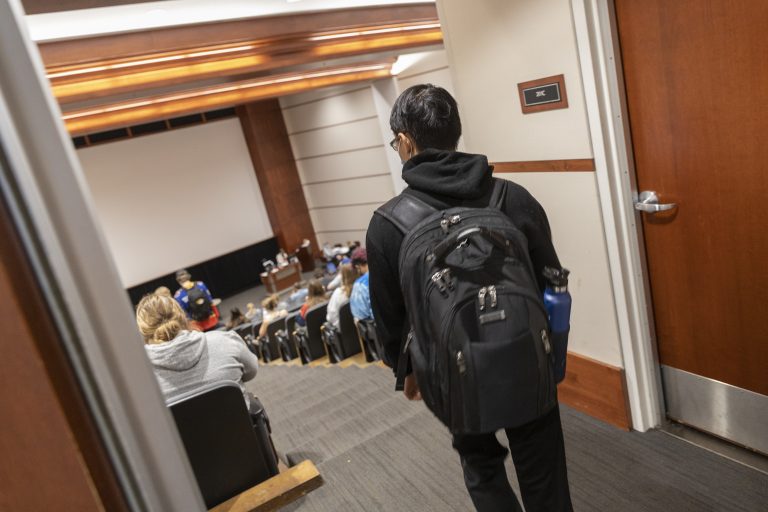 Peter Chau walks in to class in Cornell Hall 