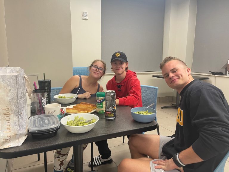 Students enjoy a family-style meal.