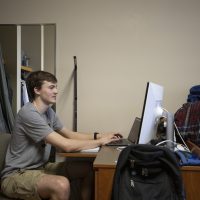 A man works at a desktop computer