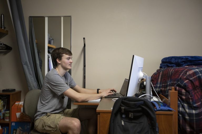 A man works at a desktop computer