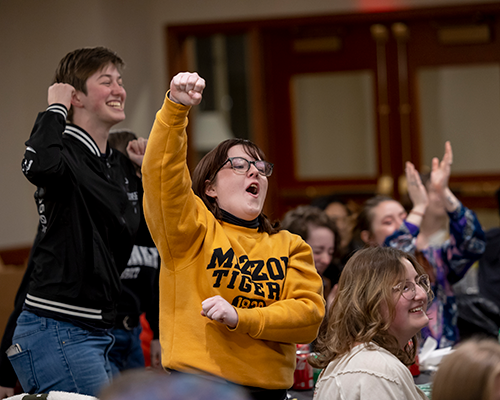 Students cheering at event.