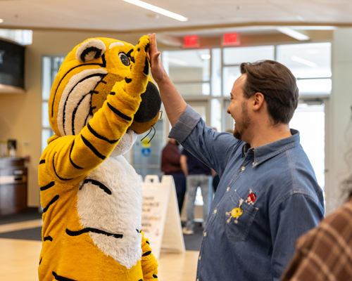 Staff member high fiving Truman.