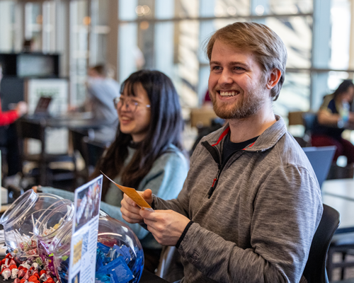 Students handing out supplies at event.